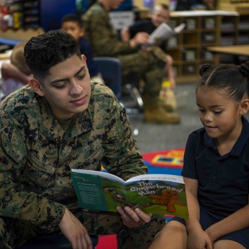 military father reading book with child at YMCA military father reading book with child at YMCA