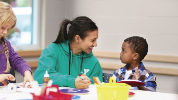 YMCA staff helping child